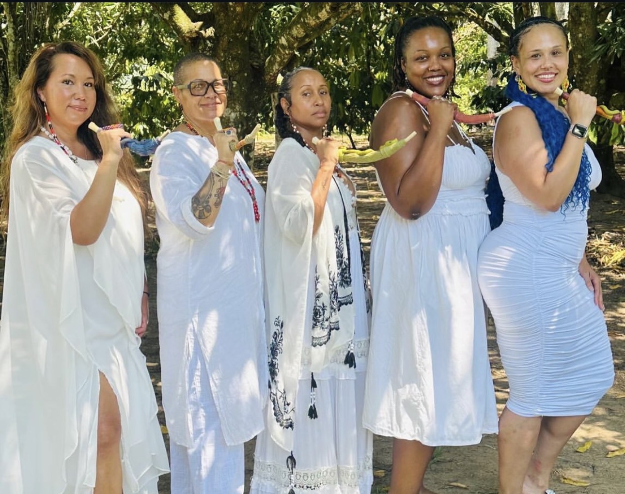 Group of women practitioners holding ceremonial Tepies